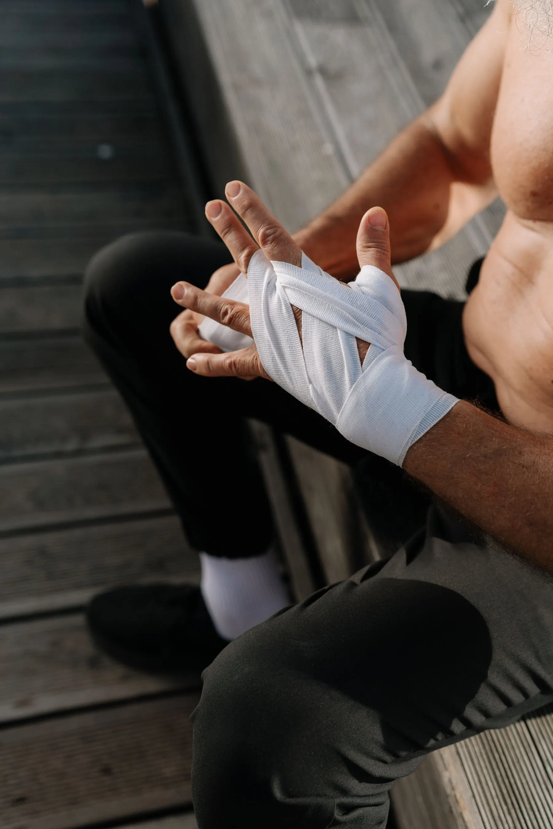 Cloth wraps being applied evenly around the hand and wrist.