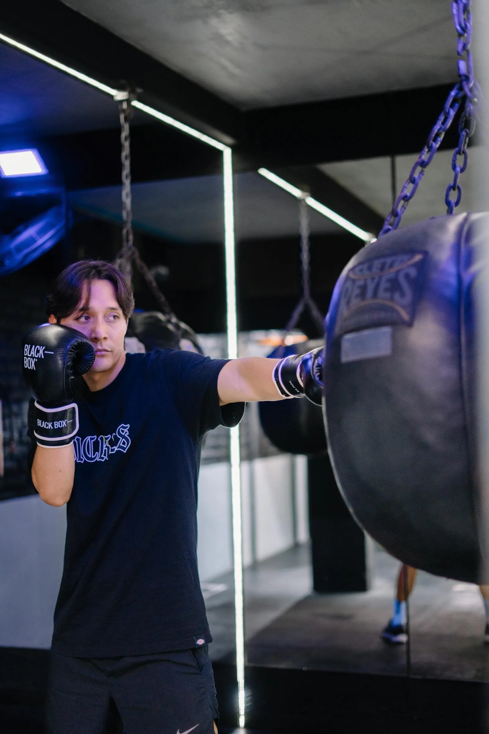Focused boxing workout on a punching bag.