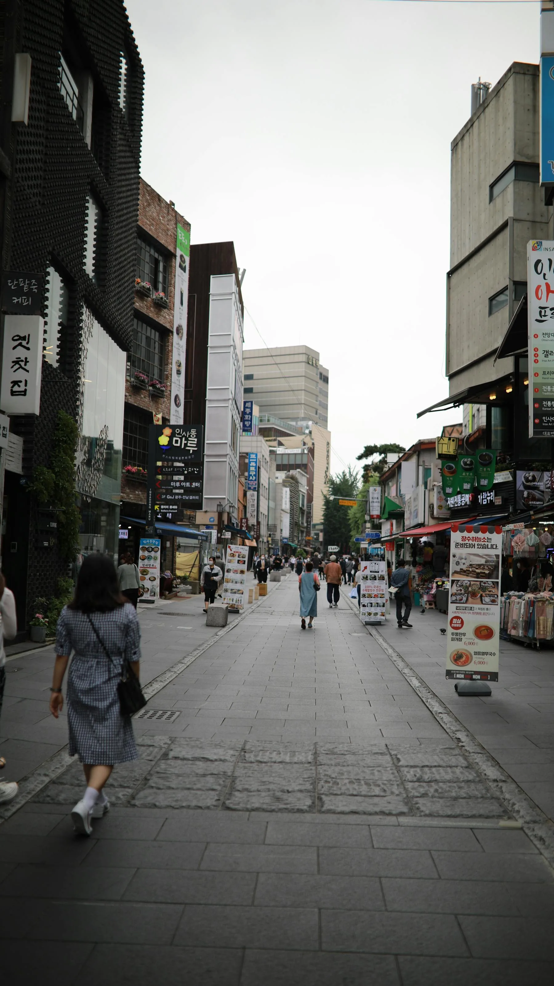 People walking through a busy street in Korea.