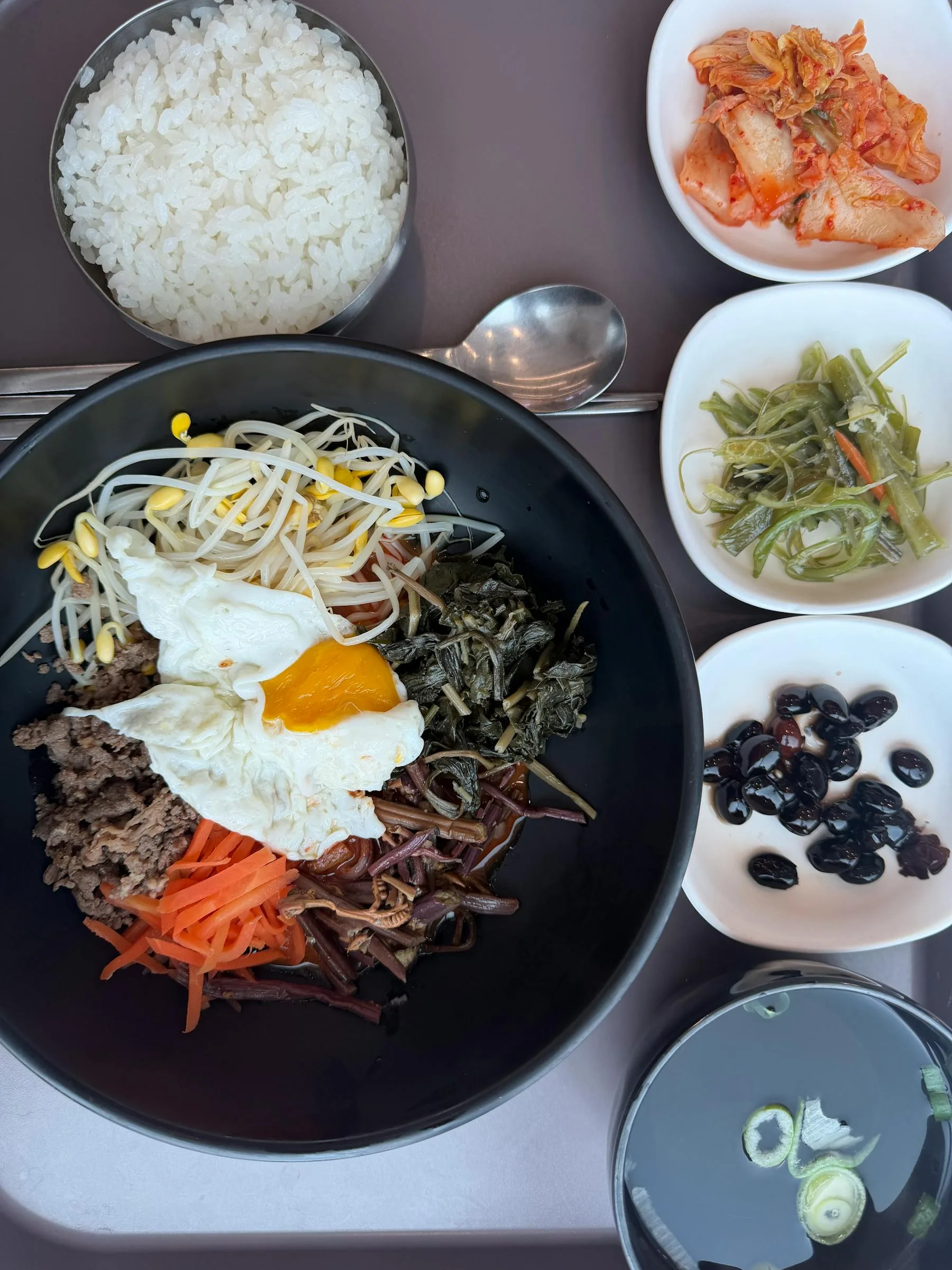 Traditional Korean bibimbap with side dishes.