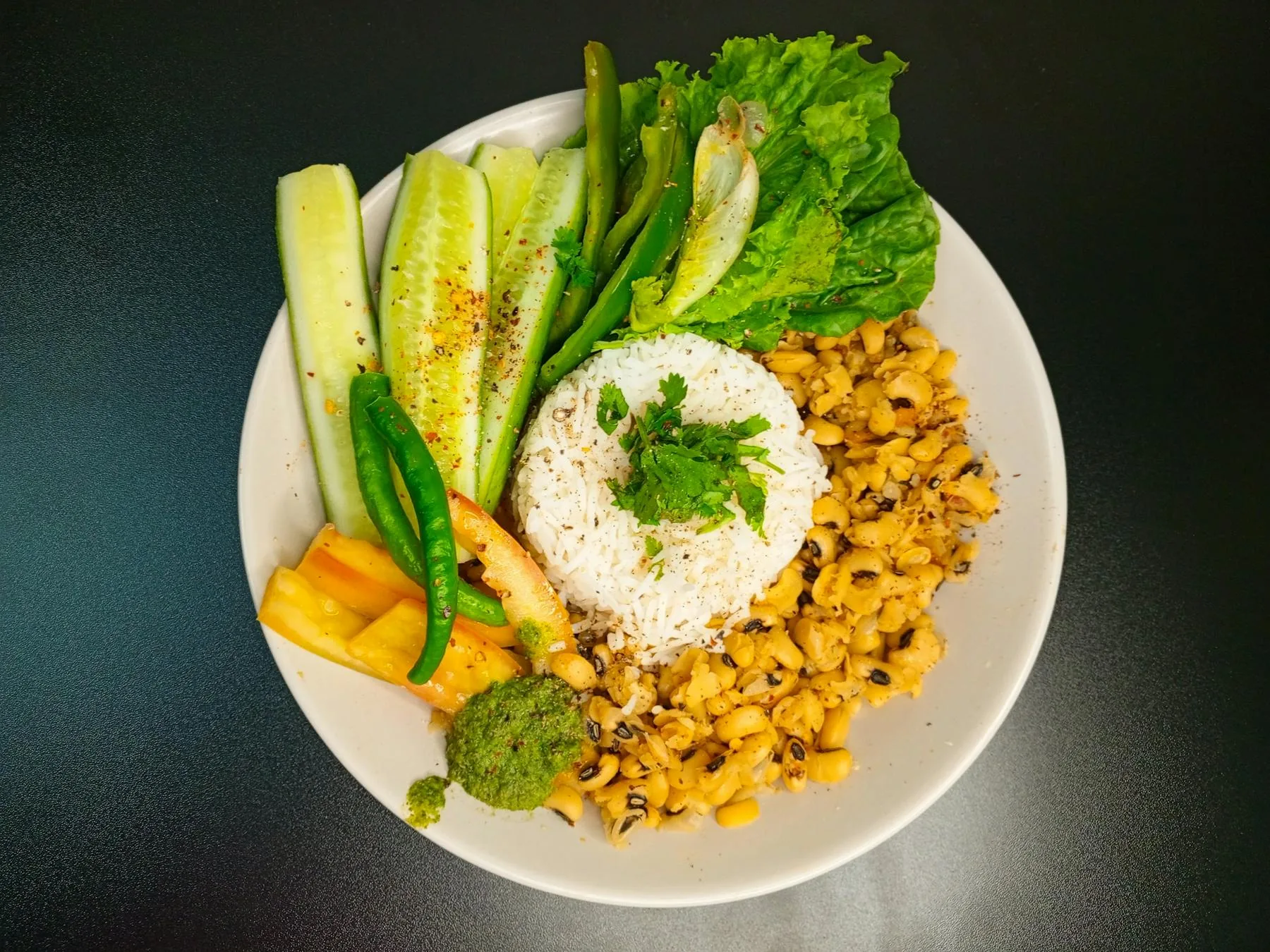 Plate of rice, beans, and vegetables arranged as a balanced meal.