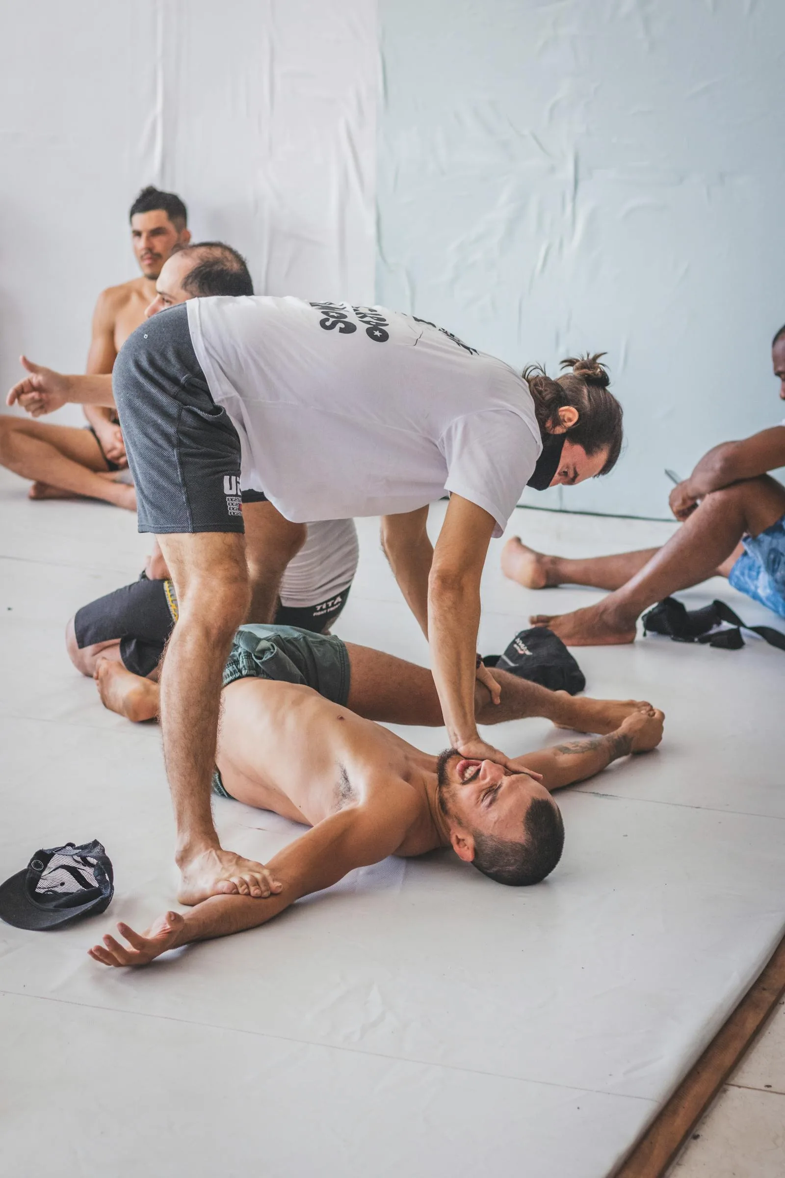 Coach correcting a group exercise position in a class setting.