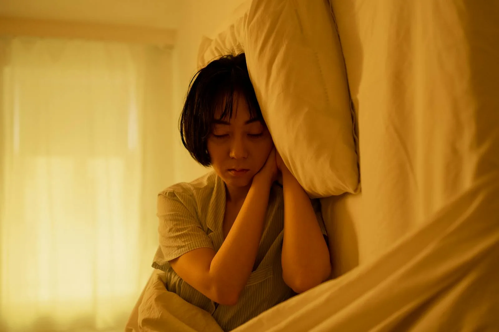 Resting woman in bed used for recovery and stress context.