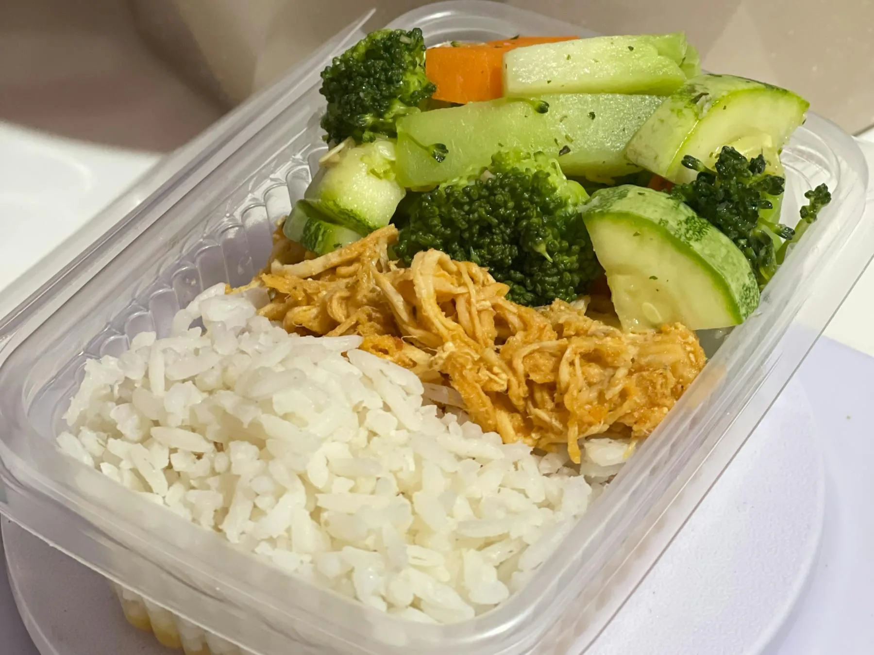 Lunch box with rice, chicken, and vegetables.