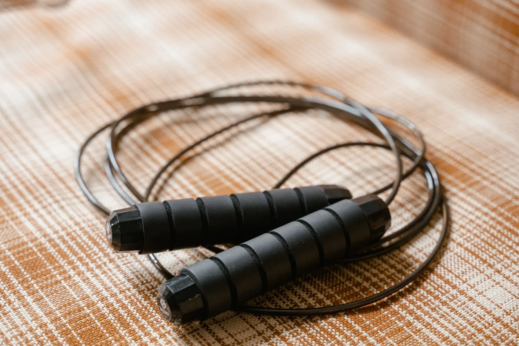 A simple jump rope laid out before a beginner practice session.