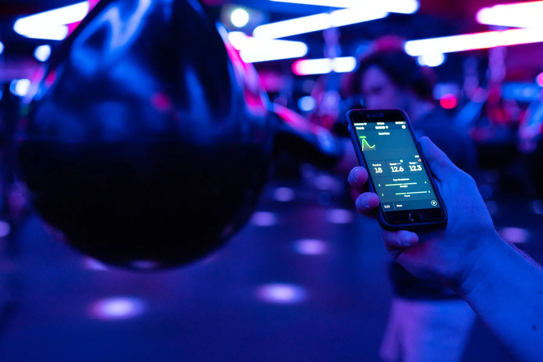 Smartphone used beside boxing equipment, supporting quick phrase and translation lookups.