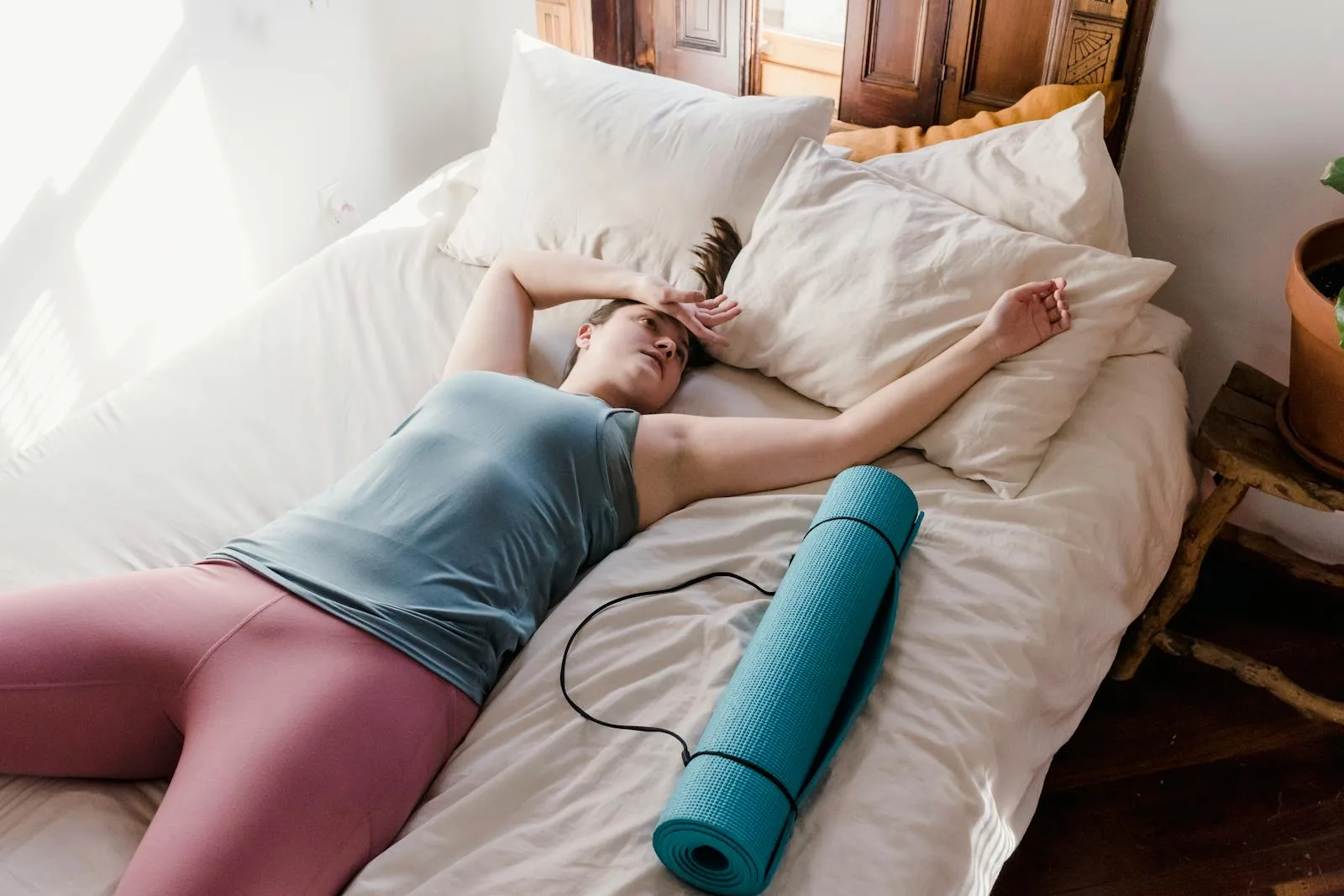 Tired person lying down after a workout for recovery context.