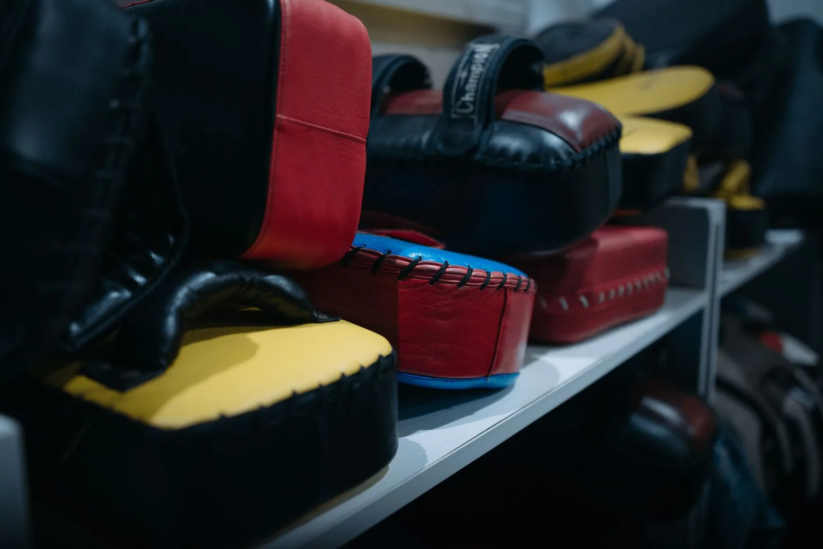 Boxing focus mitts on a shelf, used for gear and session preparation context.