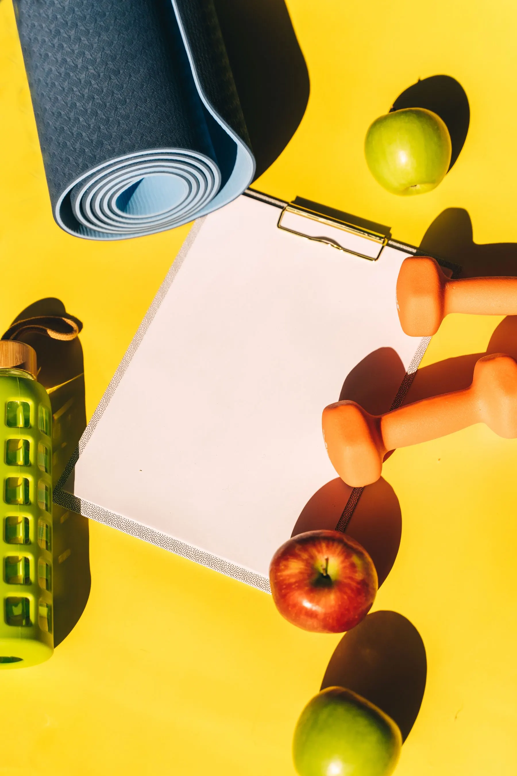 Fitness equipment and a blank training planner used to map sessions and recovery days.