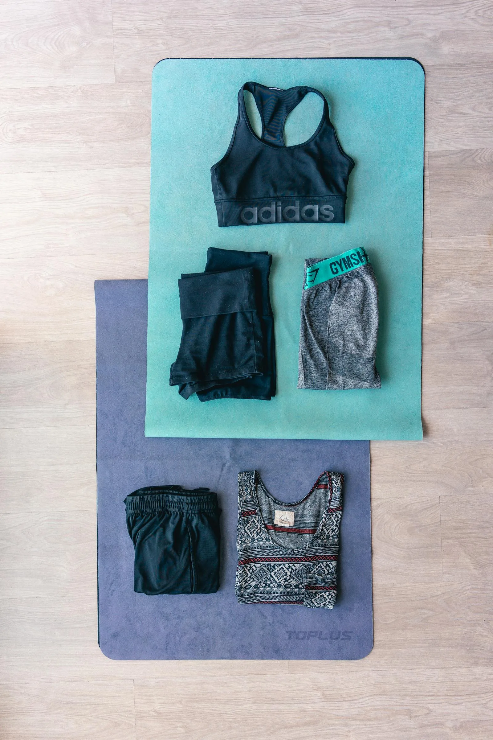 Flat lay of workout clothes and fitness gear.