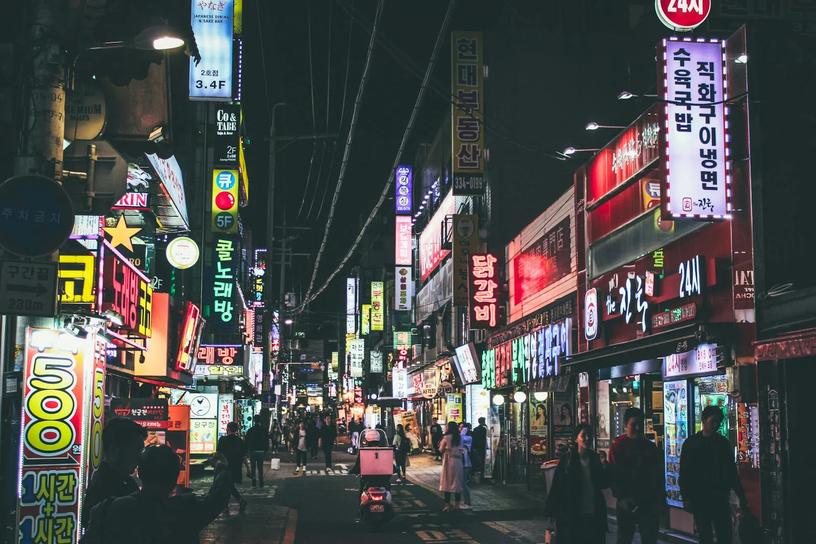 Neon Seoul street at night used to show commute and schedule friction.